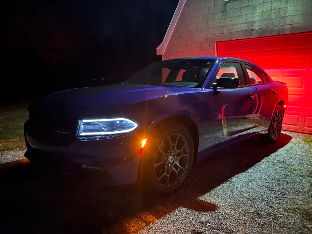 Purple Dodge Charger sitting in driveway in front of garage door