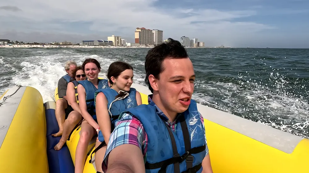 Family in yellow boat on water in Gulf of Mexic